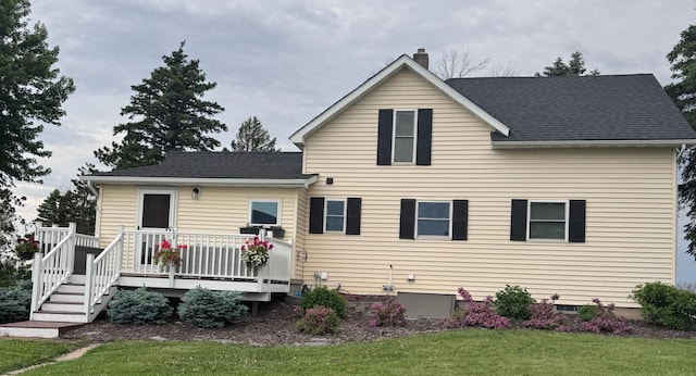 8339 71st St, West Concord, MN 55985 - back of house with a deck, a lawn, a chimney, and roof with shingles