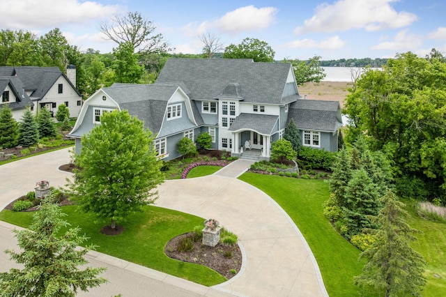 3758 Woodland Cove Pkwy, Minnetrista, MN 55331 - shingle-style home with a front lawn, curved driveway, and a shingled roof