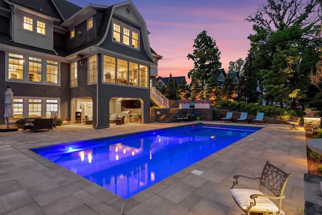 3758 Woodland Cove Pkwy, Minnetrista, MN 55331 - pool at dusk with an outdoor living space, a patio area, stairs, and an outdoor pool