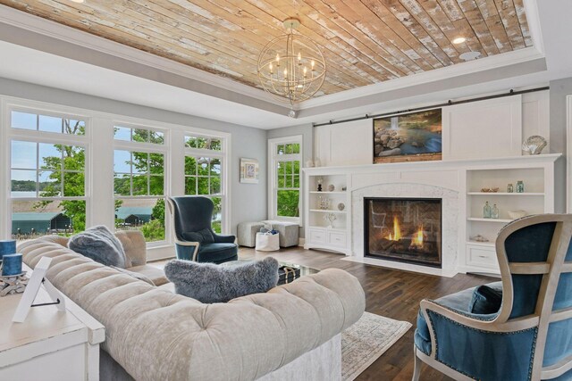 3758 Woodland Cove Pkwy, Minnetrista, MN 55331 - living room featuring wood ceiling, a tray ceiling, ornamental molding, a chandelier, and a premium fireplace