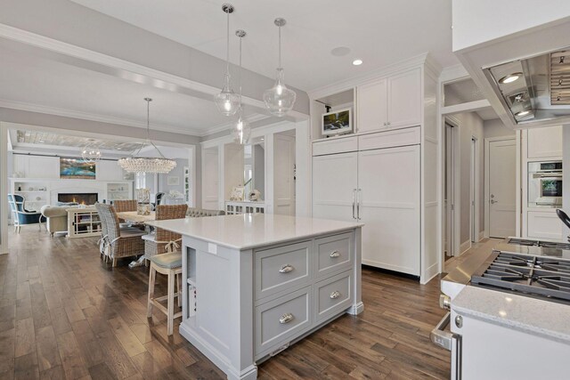 3758 Woodland Cove Pkwy, Minnetrista, MN 55331 - kitchen featuring oven, dark wood-style floors, ornamental molding, a breakfast bar, and white cabinets