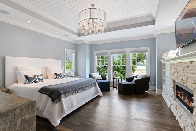 3758 Woodland Cove Pkwy, Minnetrista, MN 55331 - bedroom featuring a raised ceiling, a chandelier, dark wood-style floors, a stone fireplace, and recessed lighting