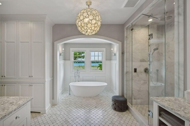 3758 Woodland Cove Pkwy, Minnetrista, MN 55331 - full bath featuring a shower stall, a decorative wall, a freestanding bath, vanity, and a wainscoted wall