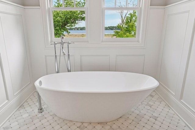 3758 Woodland Cove Pkwy, Minnetrista, MN 55331 - bathroom featuring a decorative wall, tile patterned floors, and a soaking tub
