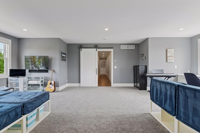 3758 Woodland Cove Pkwy, Minnetrista, MN 55331 - bedroom with a barn door, carpet, and recessed lighting