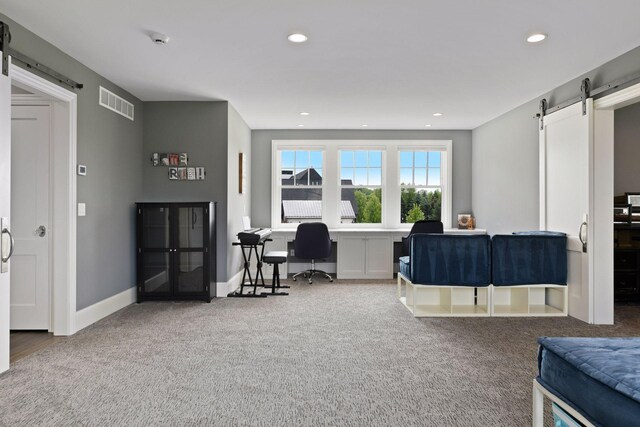 3758 Woodland Cove Pkwy, Minnetrista, MN 55331 - home office with a barn door, carpet flooring, and recessed lighting