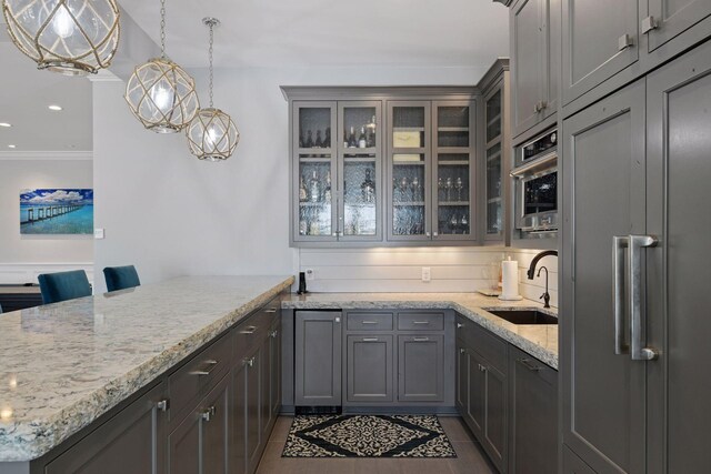 3758 Woodland Cove Pkwy, Minnetrista, MN 55331 - kitchen with a peninsula, glass insert cabinets, light stone countertops, gray cabinets, and recessed lighting