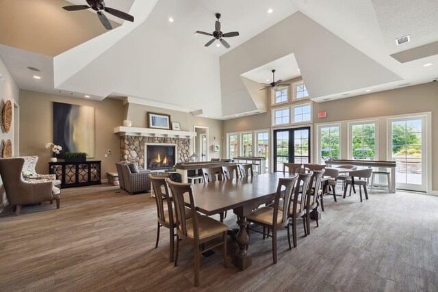 3758 Woodland Cove Pkwy, Minnetrista, MN 55331 - dining room featuring ceiling fan, high vaulted ceiling, a fireplace, wood finished floors, and recessed lighting
