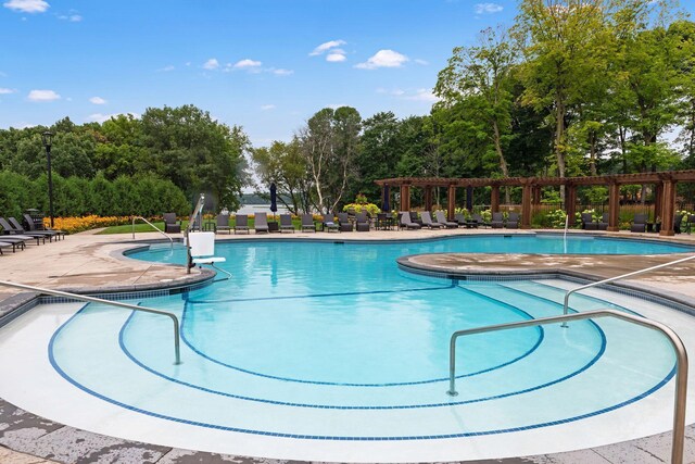 3758 Woodland Cove Pkwy, Minnetrista, MN 55331 - community pool with a pergola, a patio area, and view of scattered trees