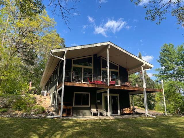 6543 Point Dr, Ideal Twp, MN 56474 - back of property featuring a lawn and a wooden deck