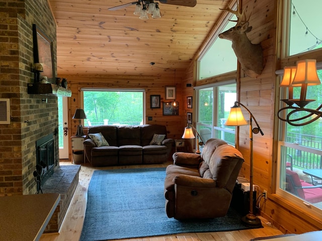 6543 Point Dr, Ideal Twp, MN 56474 - living area with hardwood / wood-style floors, ceiling fan, plenty of natural light, high vaulted ceiling, and wood walls