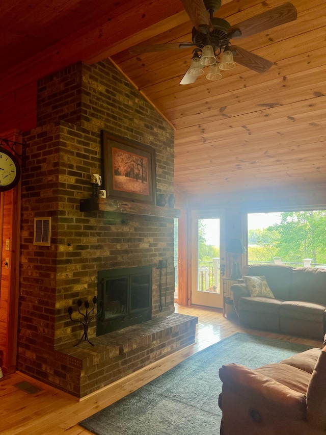 6543 Point Dr, Ideal Twp, MN 56474 - living area featuring lofted ceiling, wooden ceiling, a brick fireplace, ceiling fan, and wood finished floors
