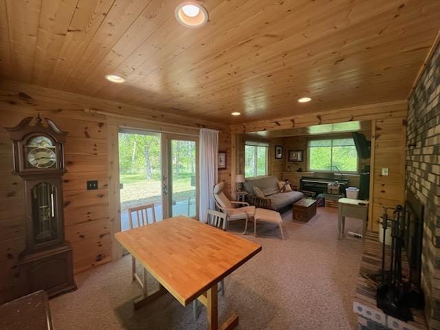 6543 Point Dr, Ideal Twp, MN 56474 - dining space with wood ceiling, a fireplace, wood walls, recessed lighting, and light carpet