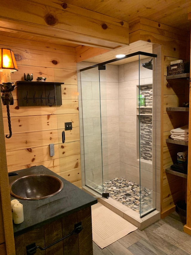 6543 Point Dr, Ideal Twp, MN 56474 - bathroom featuring a stall shower, wood finished floors, wooden ceiling, a sink, and wooden walls