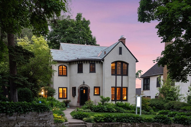 2248 Goodrich Ave, Saint Paul, MN 55105 - view of front of home with a chimney, stucco siding, and a high end roof