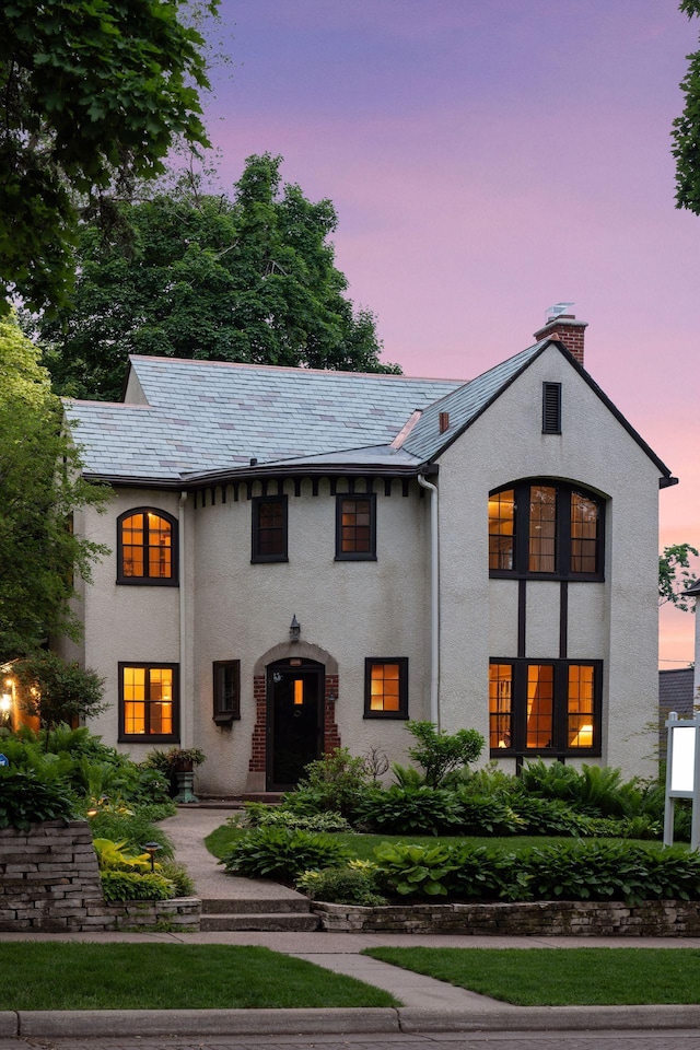 2248 Goodrich Ave, Saint Paul, MN 55105 - view of front of property with a chimney, stucco siding, and a high end roof