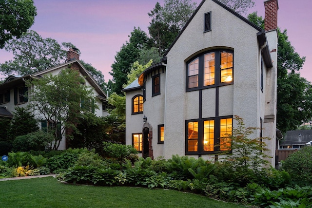 2248 Goodrich Ave, Saint Paul, MN 55105 - view of front facade featuring a chimney, stucco siding, and a front yard