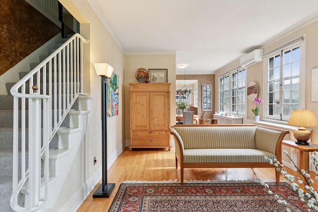 2248 Goodrich Ave, Saint Paul, MN 55105 - sitting room featuring light wood-type flooring, stairway, an AC wall unit, crown molding, and a chandelier
