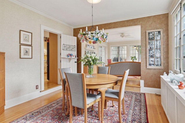 2248 Goodrich Ave, Saint Paul, MN 55105 - dining room with light wood-style flooring, baseboards, crown molding, and a ceiling fan