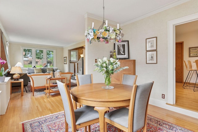 2248 Goodrich Ave, Saint Paul, MN 55105 - dining space with light wood-style flooring, crown molding, and baseboards