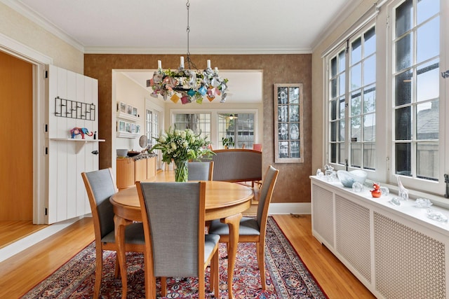 2248 Goodrich Ave, Saint Paul, MN 55105 - dining room with light wood finished floors, healthy amount of natural light, baseboards, a chandelier, and ornamental molding
