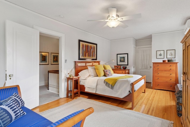 2248 Goodrich Ave, Saint Paul, MN 55105 - bedroom featuring light wood-style floors, a closet, a ceiling fan, and a wall mounted air conditioner