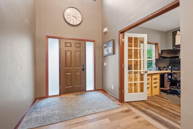 4027 148th Ln NE, Ham Lake, MN 55304 - foyer entrance with light wood-style flooring and a towering ceiling