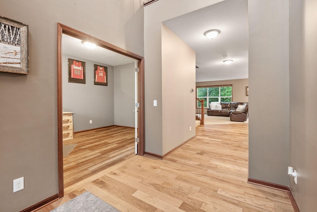 4027 148th Ln NE, Ham Lake, MN 55304 - corridor featuring light wood-style flooring and baseboards