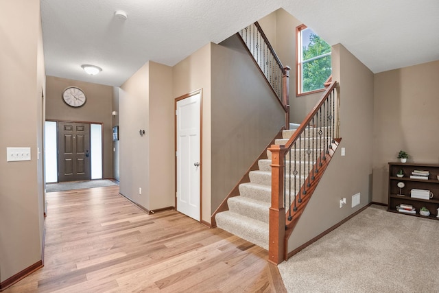 4027 148th Ln NE, Ham Lake, MN 55304 - foyer entrance with light wood finished floors and stairs