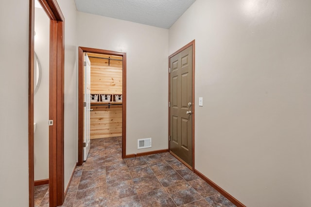 4027 148th Ln NE, Ham Lake, MN 55304 - hallway featuring stone finish floors and a textured ceiling