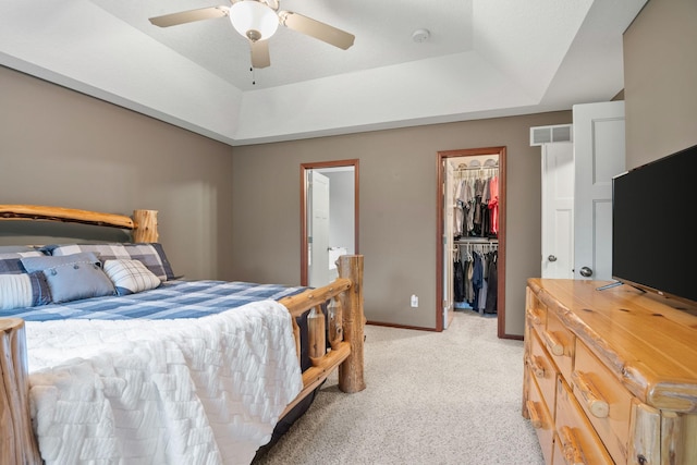 4027 148th Ln NE, Ham Lake, MN 55304 - bedroom featuring a tray ceiling, light colored carpet, a spacious closet, a closet, and ceiling fan