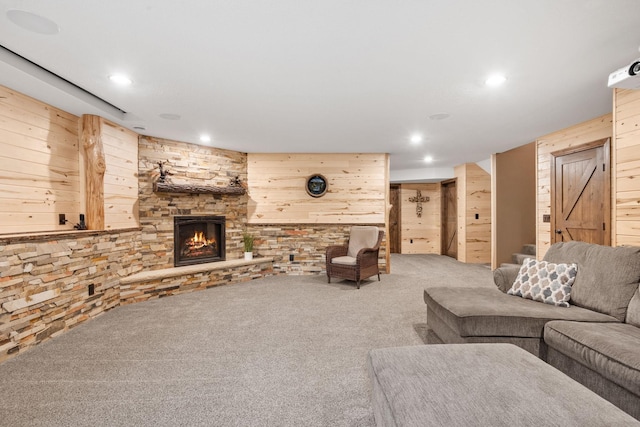4027 148th Ln NE, Ham Lake, MN 55304 - living room featuring carpet floors, wood walls, a fireplace, and recessed lighting