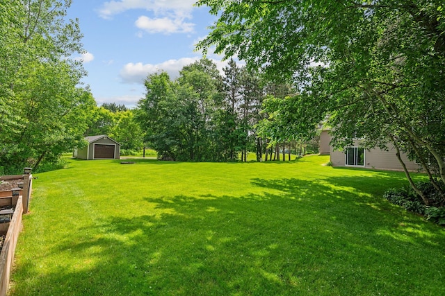 4027 148th Ln NE, Ham Lake, MN 55304 - view of grassy yard featuring a detached garage and an outbuilding