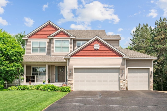 4027 148th Ln NE, Ham Lake, MN 55304 - craftsman house featuring driveway, an attached garage, a front yard, and stone siding