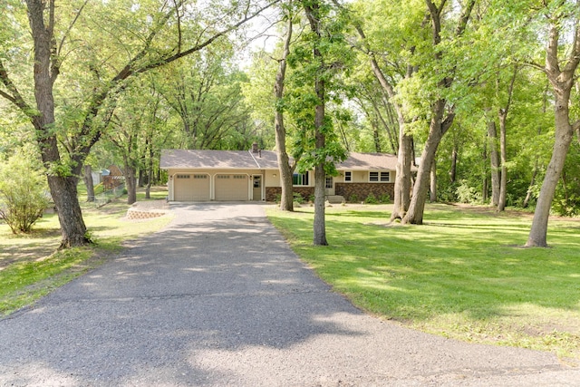 13500 190th Ave NW, Elk River, MN 55330 - ranch-style home featuring a garage, asphalt driveway, and a front yard