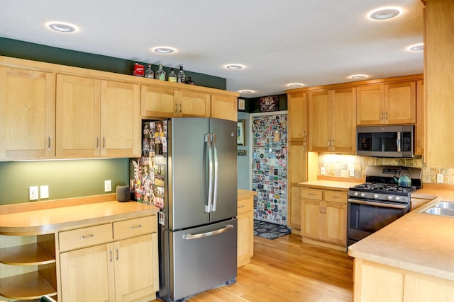 13500 190th Ave NW, Elk River, MN 55330 - kitchen featuring appliances with stainless steel finishes, light brown cabinets, light countertops, and light wood-style floors