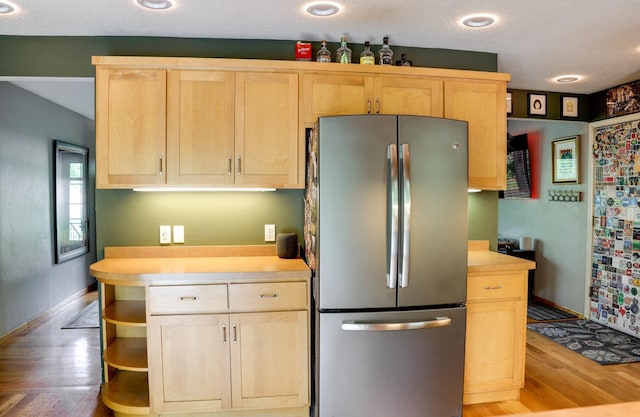 13500 190th Ave NW, Elk River, MN 55330 - kitchen with freestanding refrigerator, light brown cabinetry, baseboards, light wood-style floors, and light countertops