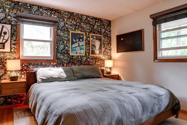 13500 190th Ave NW, Elk River, MN 55330 - bedroom with wallpapered walls and wood finished floors