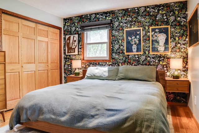 13500 190th Ave NW, Elk River, MN 55330 - bedroom featuring wallpapered walls, wood finished floors, and a closet