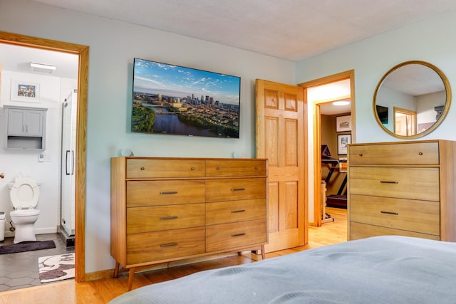 13500 190th Ave NW, Elk River, MN 55330 - bedroom featuring light wood finished floors, connected bathroom, and baseboards