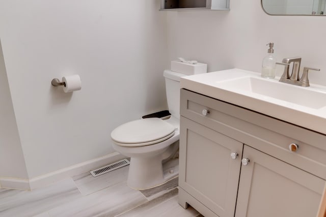 13500 190th Ave NW, Elk River, MN 55330 - half bathroom featuring toilet, vanity, and baseboards