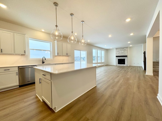 9901 49th St NE, Saint Michael, MN 55376 - kitchen featuring dishwasher, a center island, light wood finished floors, light countertops, and recessed lighting