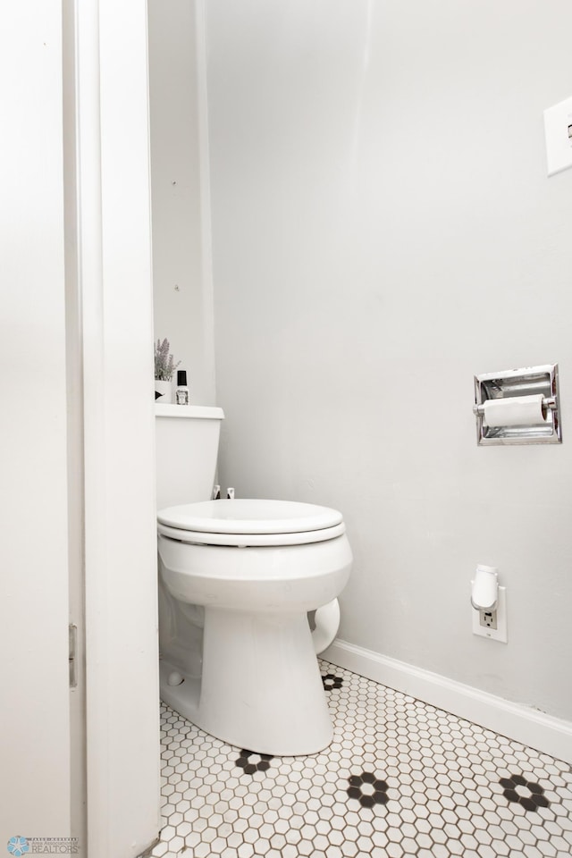 1345 4th St N, Fargo, ND 58102 - bathroom featuring toilet, baseboards, and tile patterned floors