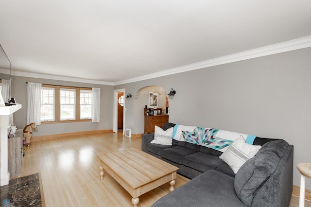 1345 4th St N, Fargo, ND 58102 - living area with crown molding, light wood-style floors, arched walkways, and baseboards