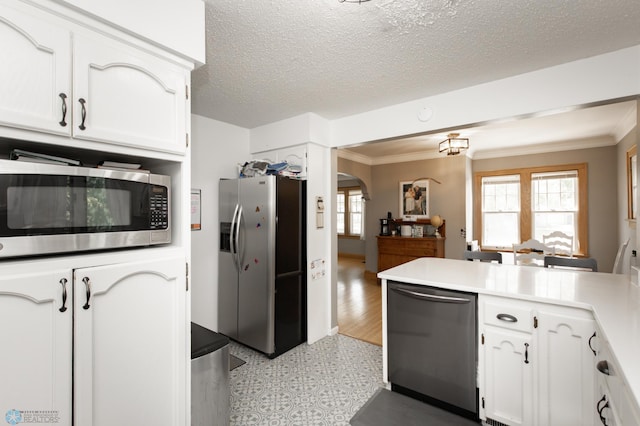 1345 4th St N, Fargo, ND 58102 - kitchen with stainless steel appliances, arched walkways, ornamental molding, white cabinetry, and light flooring