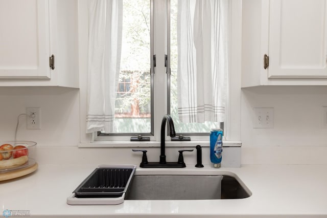 1345 4th St N, Fargo, ND 58102 - kitchen with white cabinets, a sink, and light countertops