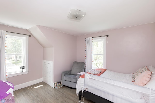 1345 4th St N, Fargo, ND 58102 - bedroom with multiple windows, wood finished floors, and baseboards