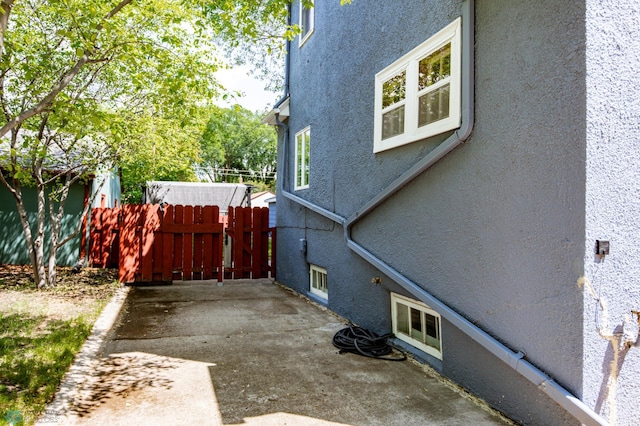 1345 4th St N, Fargo, ND 58102 - view of property exterior with stucco siding and a patio