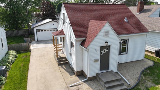 951 13th Ave NE, Rochester, MN 55906 - view of front of property featuring roof with shingles, an outdoor structure, a detached garage, and a chimney