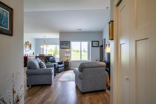 1320 Whiting Rd NW Unit 71, Bemidji, MN 56601 - living room featuring wood finished floors and a chandelier